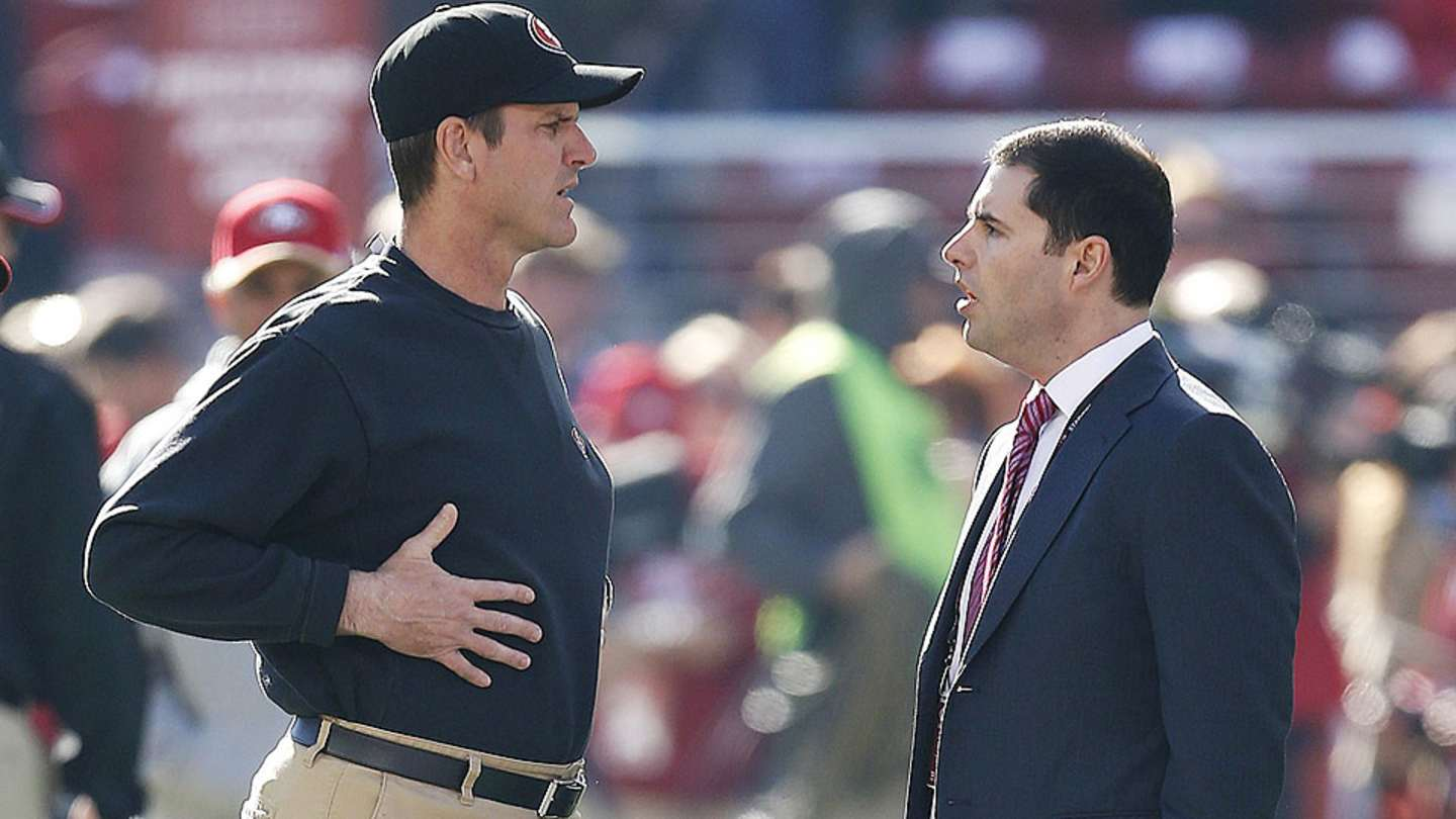 Jed York and Jim Harbaugh at a press conference